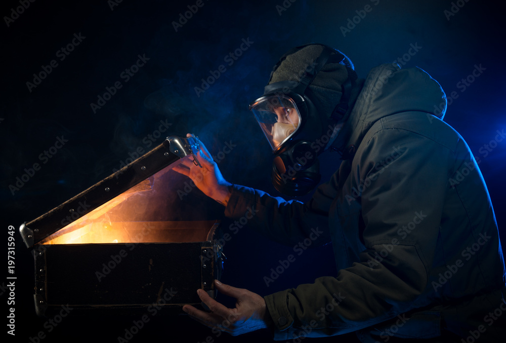 the man in the gas mask opens an old suitcase the man in the gas mask opens an old suitcase
