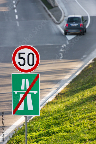 50 km/h speed limit traffic sign and the end of highway sign