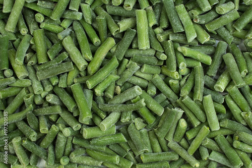 frozen chopped asparagus beans. top view. background green wax beans.