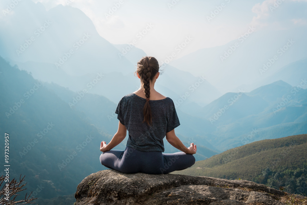 Woman meditates in yoga asana Padmasana - obrazy, fototapety, plakaty 