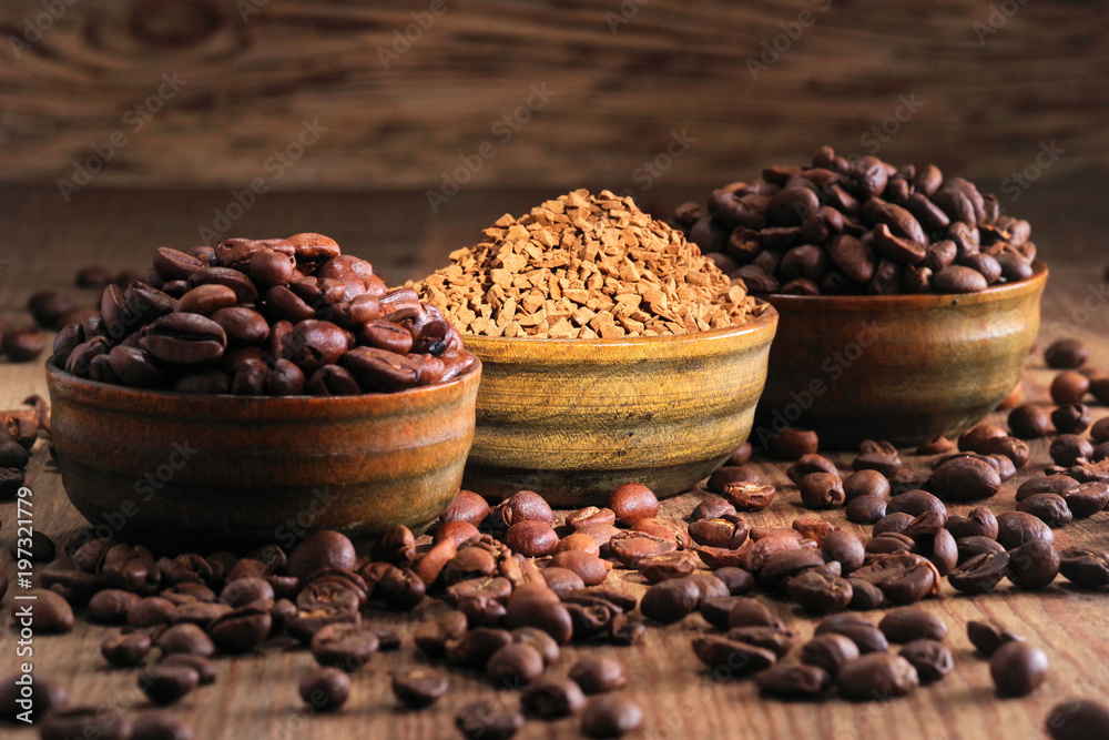 Coffee beans pile and coffe instant on the background of ground coffee Coffee beans pile and coffe instant on the background of ground coffee
