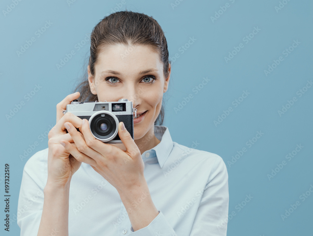 Photographer woman holding a camera and shooting Photographer woman holding a camera and shooting