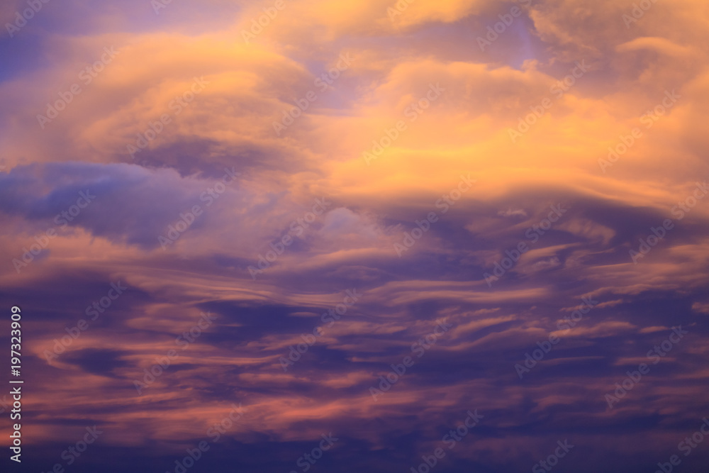A dramatic and colorful cloudy sunset sky with violet and hints of yellow