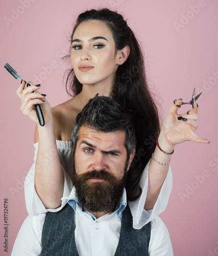 Master cuts hair and beard of man