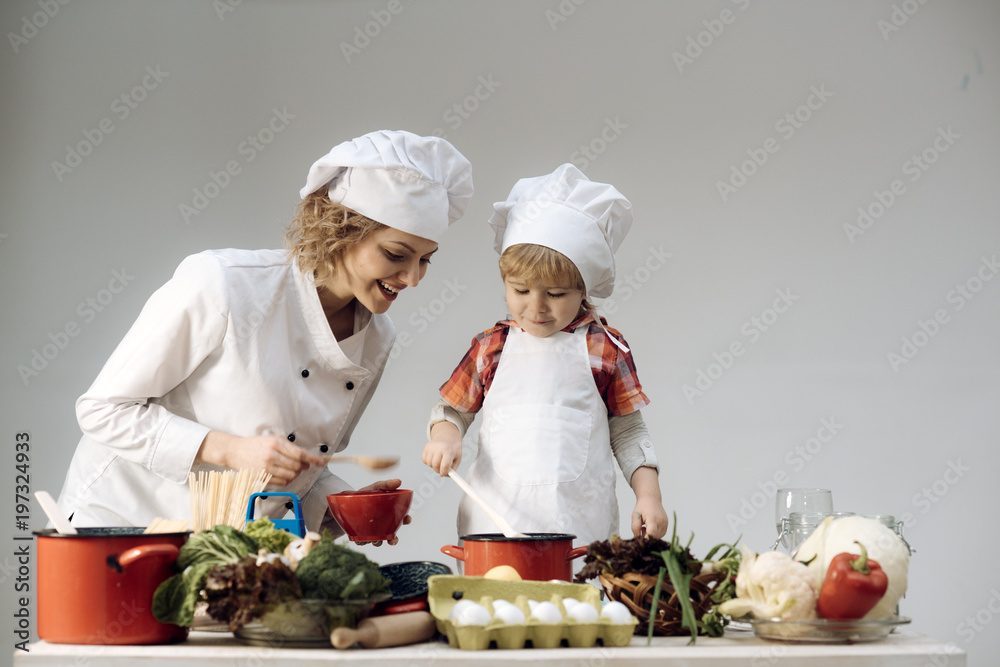 Chef and assistant near kitchen equipment and food products Chef and assistant near kitchen equipment and food products