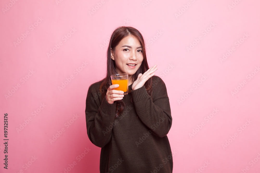 Happy Young Asian woman drink orange juice.