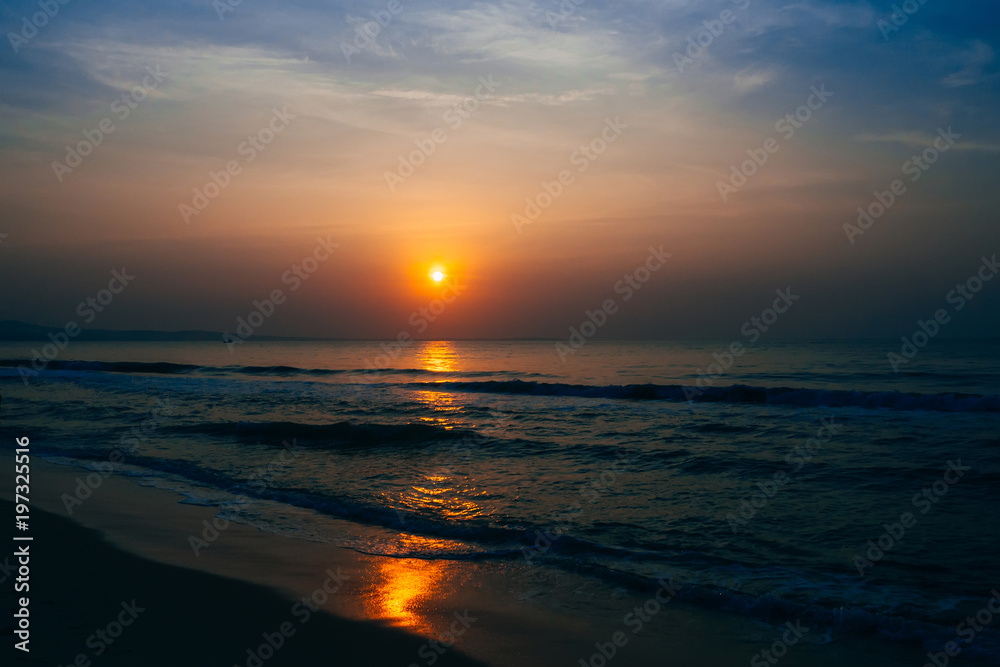 sunrise on the background of blue sky at summer sea