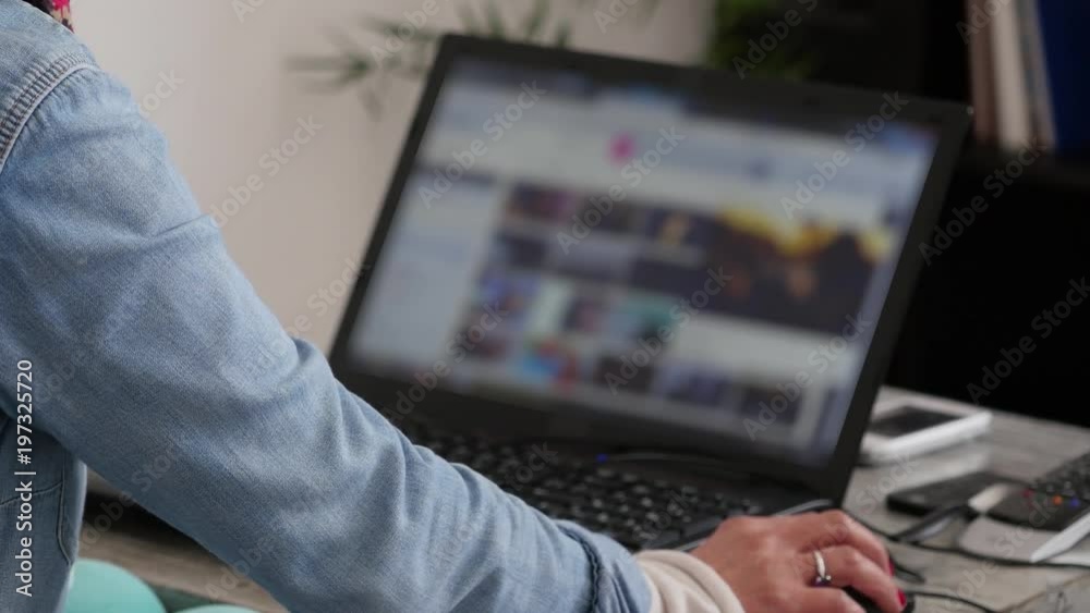 woman using a laptop in the living room woman using a laptop in the living room