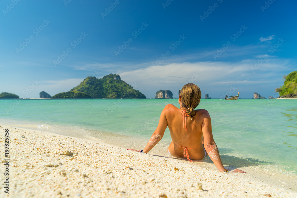 Cute woman relaxing on the tropical beach. Vacation at Paradise. Ocean beach relax, travel to islands