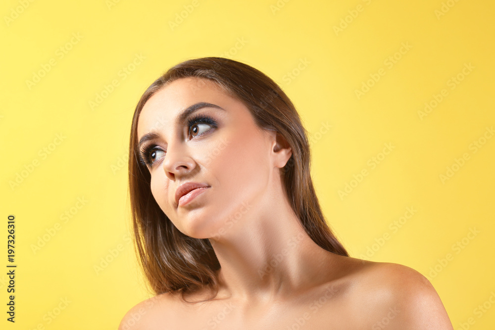 Beautiful young woman with eyelash extensions on color background Beautiful young woman with eyelash extensions on color background