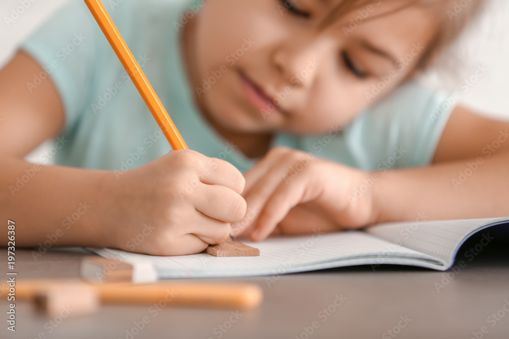 Cute little girl doing homework, closeup Cute little girl doing homework, closeup
