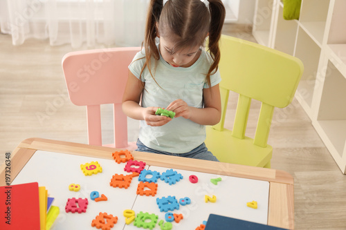 Cute little girl playing wi...