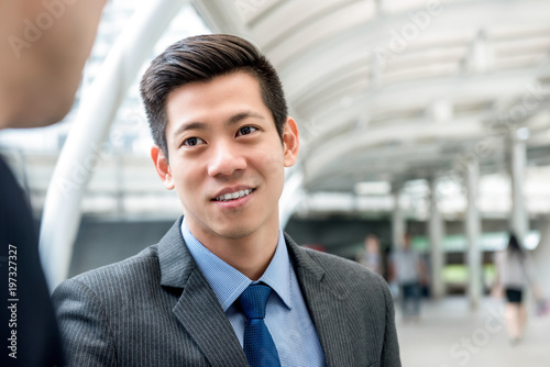 Asian Chinese businessman listening to partner with eye contact