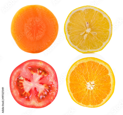 slice lemon orange tomato and carrot on white