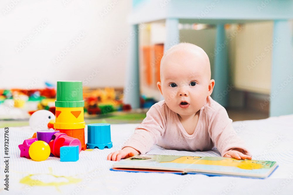 Cute baby looking and reading a book. Cute baby looking and reading a book.