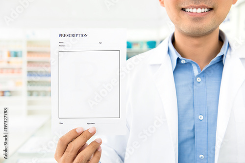 Pharmacist showing blank prescription paper