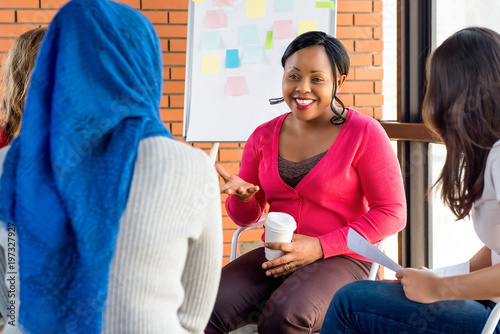 Diverse group of women in colorful clothes at the meeting photo