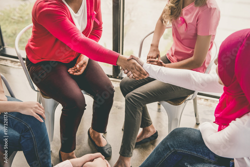 Women making handshake greeting each other in group meeting