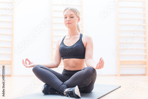 Young attractive smiling woman practicing yoga