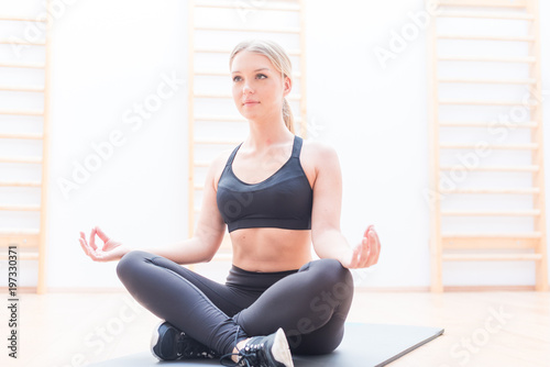 Young attractive smiling woman practicing yoga
