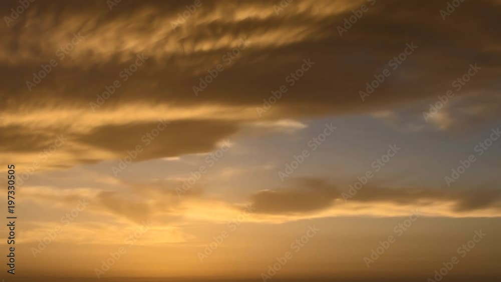 4k time lapse of clouds crossing the amazing sky over the sea or ocean at sunset. transition from day to night. The clouds cross slowly from left to right colored yellow orange purple blue. 4k time lapse of clouds crossing the amazing sky over the sea or ocean at sunset. transition from day to night. The clouds cross slowly from left to right colored yellow orange purple blue.