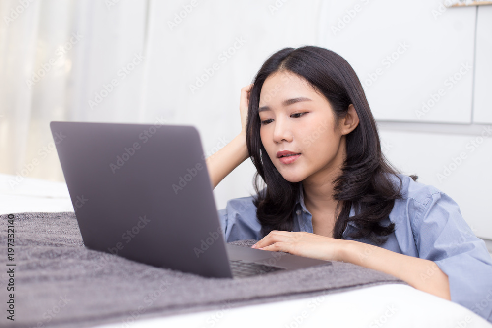 Asian woman using laptop at home. People with technology concept. Asian woman using laptop at home. People with technology concept.