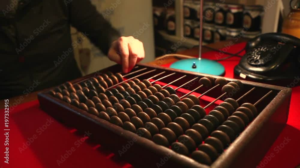 Man calling the old phone, wooden abacus in the office