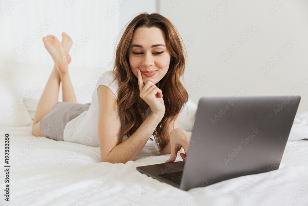 Portrait of a lovely young woman lying in bed at home Portrait of a lovely young woman lying in bed at home