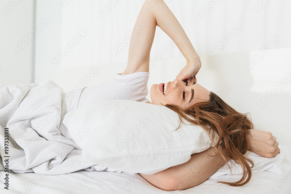 Portrait of a beautiful young woman laying in bed Portrait of a beautiful young woman laying in bed