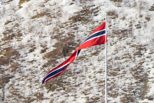 Norwegian banner on a flag pole in the arctic village of Rekvik, Kvalsoya photo