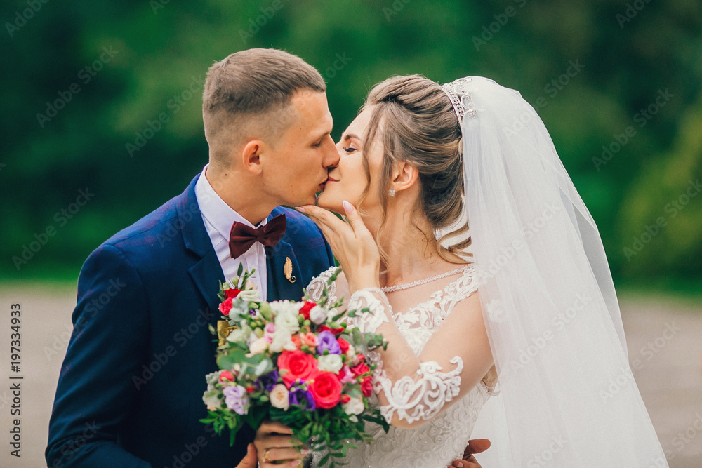 Sensual portrait of a young couple. Wedding photo outdoor. newlyweds bride and groom at a wedding in nature green forest are kissing photo portrait. Sensual portrait of a young couple. Wedding photo outdoor. newlyweds bride and groom at a wedding in nature green forest are kissing photo portrait.