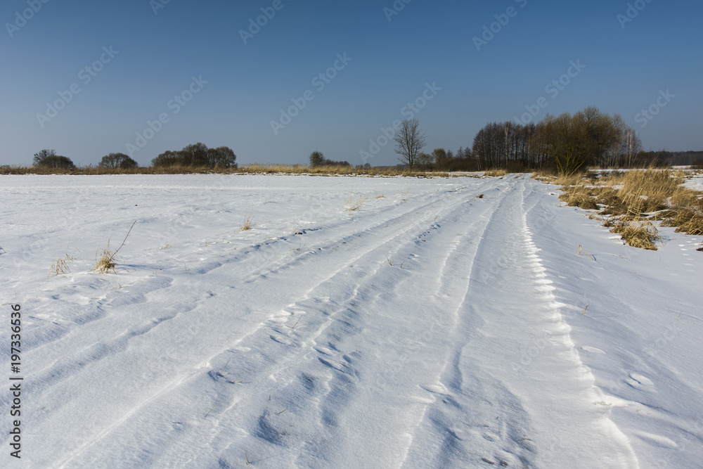 Dirt road covered with snow