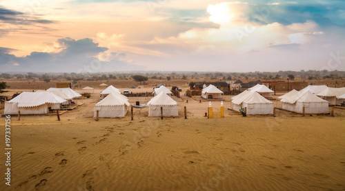 Desert sunset at Thar Jaisalmer Rajasthan with view of tourist tents used on desert safari