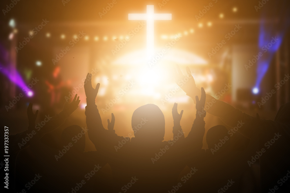 Naklejka premium Christians raising their hands in praise and worship at a night music concert. Eucharist Therapy Bless God Helping Repent Catholic Easter Lent Mind Pray. Christian concept background.