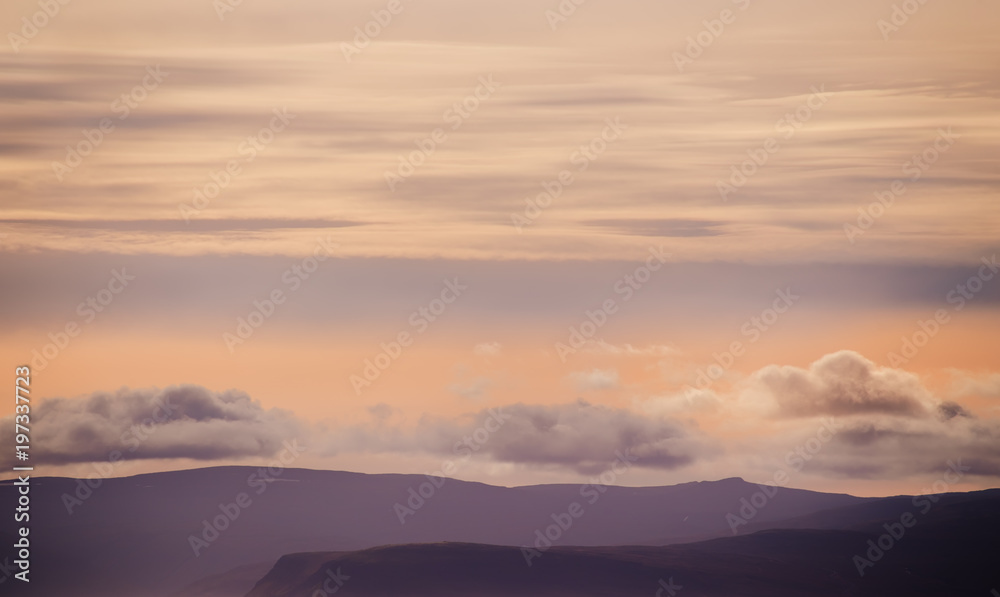 Silhouettes of mountains and clouds in the sky, Iceland landscape. Beautiful sunset light.
