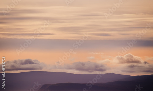 Silhouettes of mountains and clouds in the sky, Iceland landscape. Beautiful sunset light. 