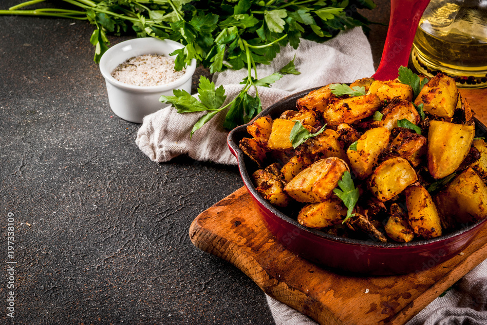 Indian food, Bombay Potatoes on dark rusty background copy space Indian food, Bombay Potatoes on dark rusty background copy space