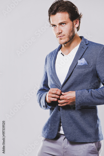 caucasian man wearing blue jacket white shirt and trendy hairstyle