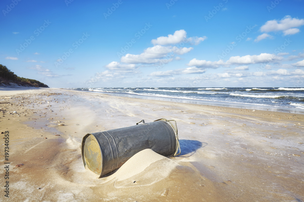 Trash can on a beach, environmental pollution concept Trash can on a beach, environmental pollution concept