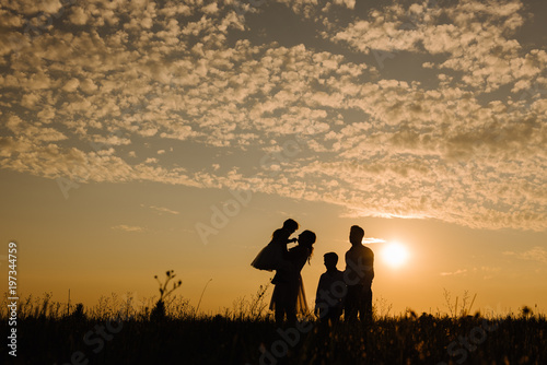 Silhouette of a family against the sky