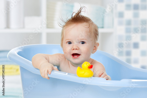 Handsome baby boy washing i...