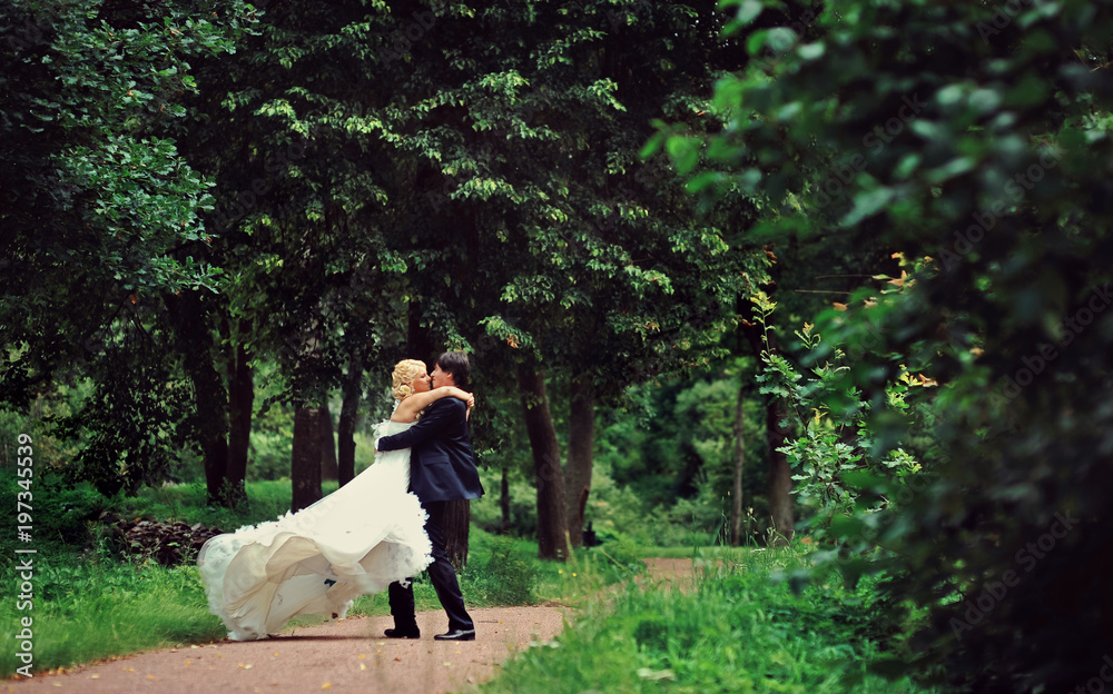 Bride and groom at wedding Day walking Outdoors on summer nature. Bridal couple, Happy Newlywed woman and man embracing in green park. Loving wedding couple outdoor. Bride and groom in honeymoon Bride and groom at wedding Day walking Outdoors on summer nature. Bridal couple, Happy Newlywed woman and man embracing in green park. Loving wedding couple outdoor. Bride and groom in honeymoon