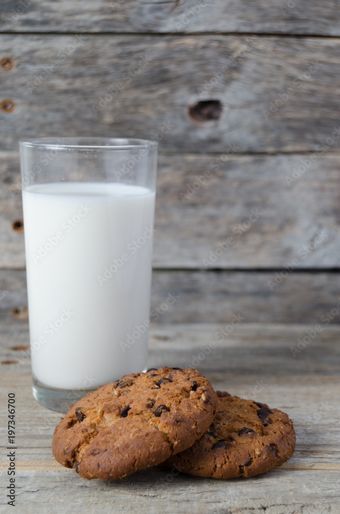 Glass of milk and cookies with chocolate chips.Village Breakfast. Glass of milk and cookies with chocolate chips.Village Breakfast.
