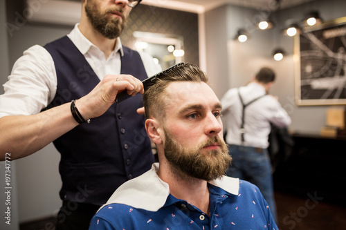 Barber combing customer hair