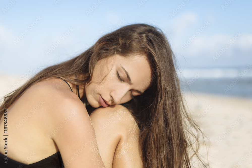 Attractive young woman with closed eyes on the beach Attractive young woman with closed eyes on the beach