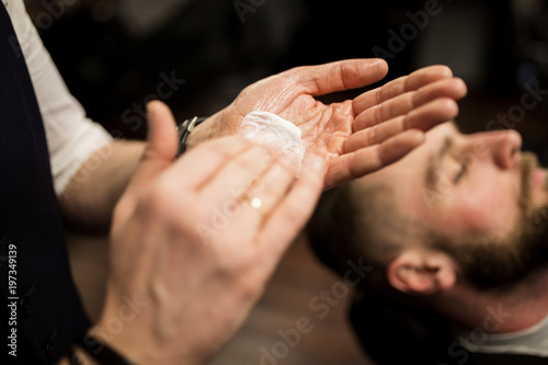 Barber hands rubbing shaving foam
