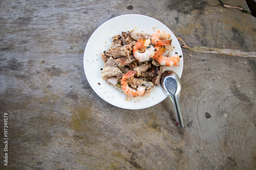 a dirty flies swarm on shrimp and pork grilled on plastic white plate with table spoon