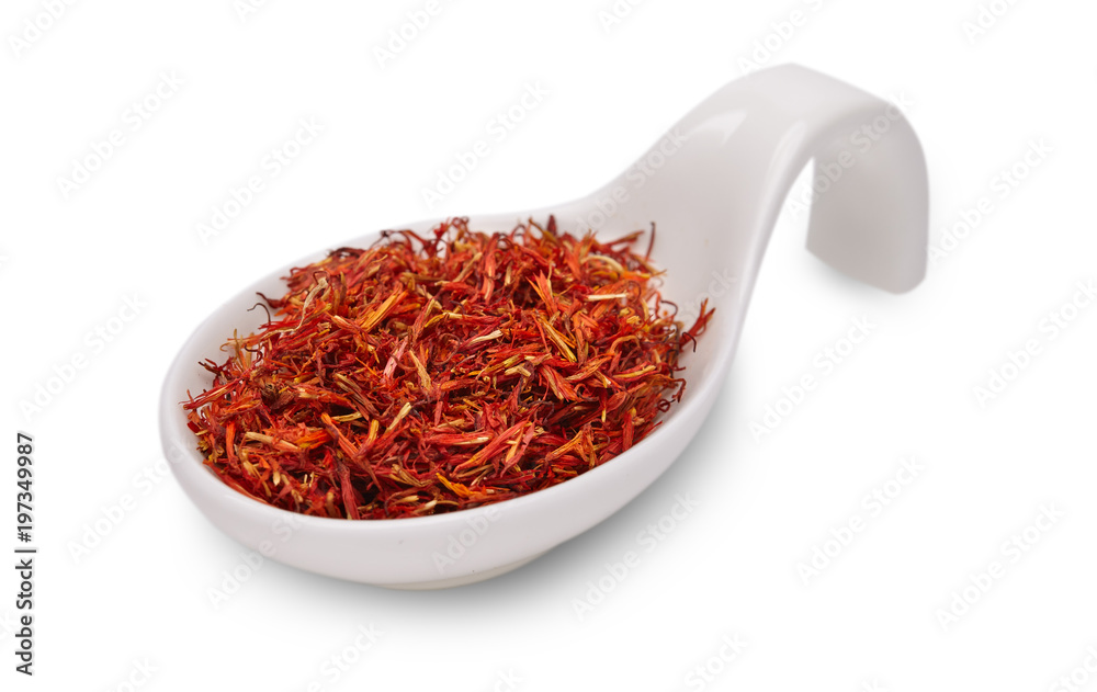 Fototapeta premium saffron in white ceramic spoon on a white background