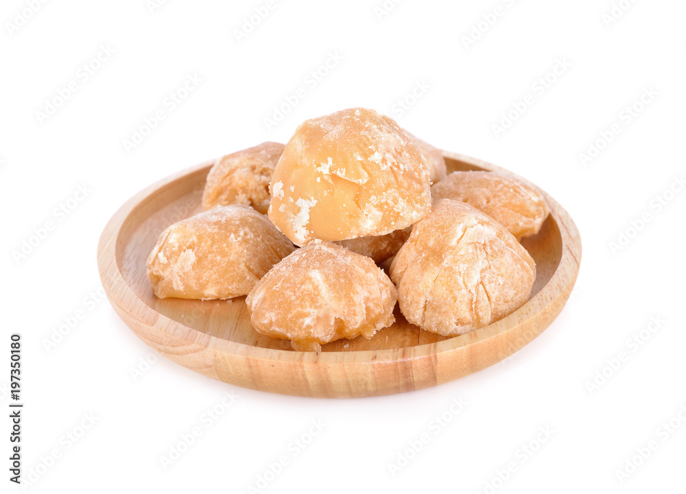 unbleached palm sugar in wooden plate on white background unbleached palm sugar in wooden plate on white background
