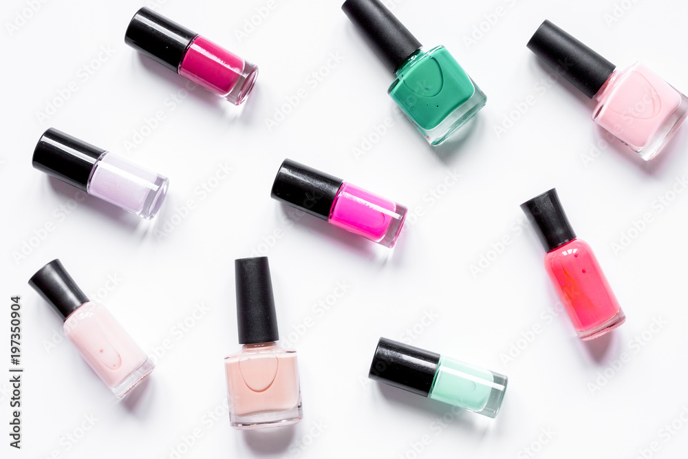 Obraz premium set for nail polish on white table background top view pattern